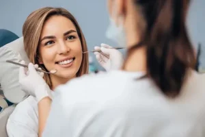 a women smiling while dental treatment